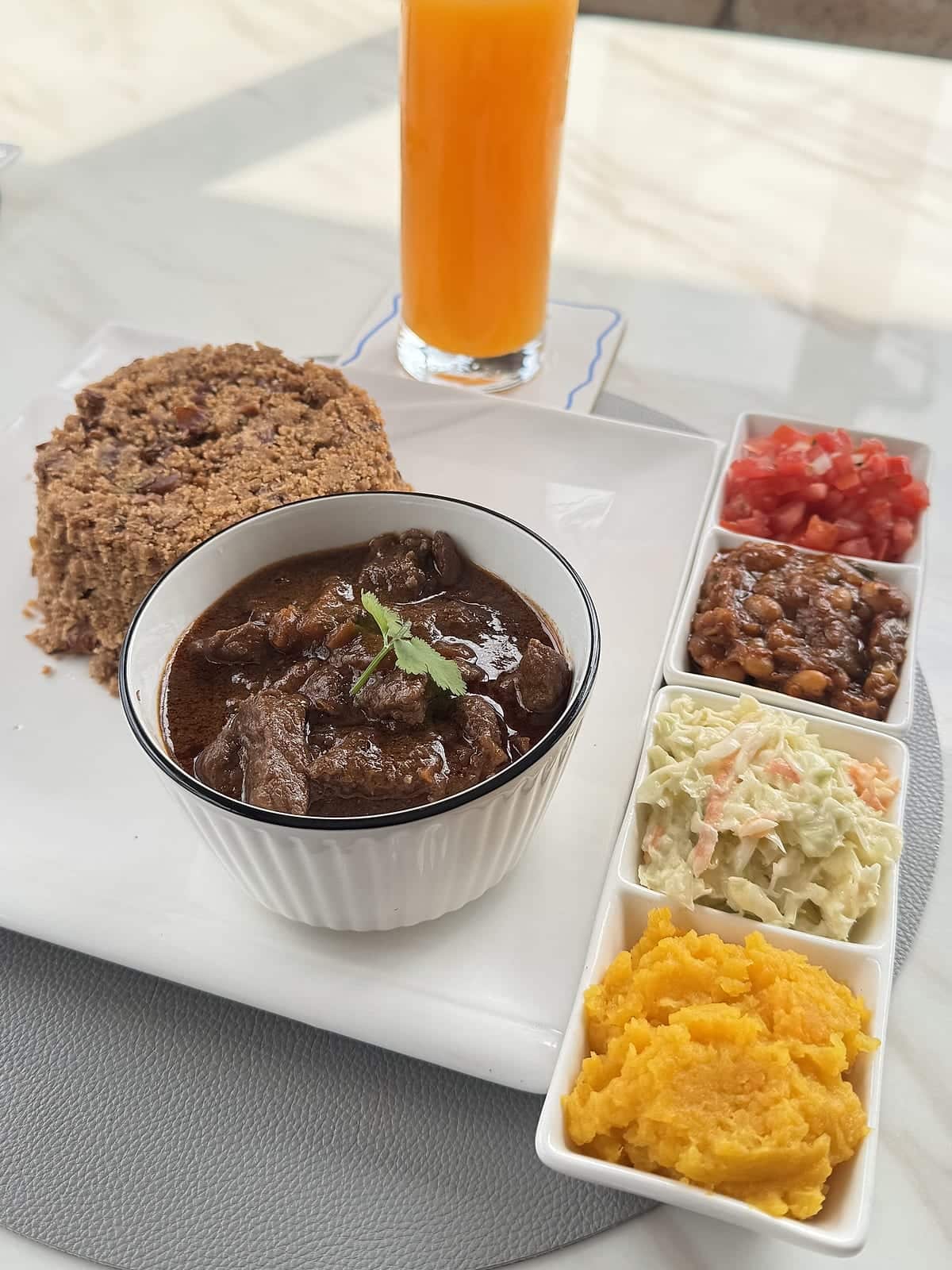 A rich beef curry with savoury rice and four fresh side dishes