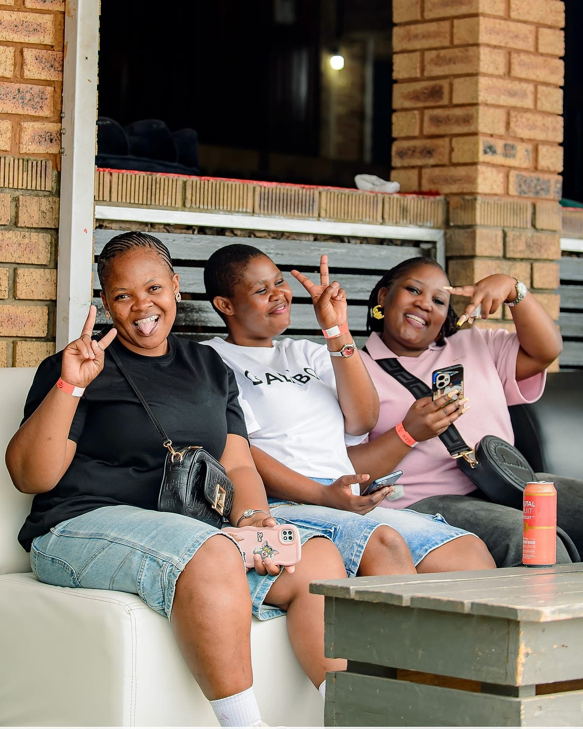Three friends on a couch at Zaba's during Durban's Summer Dance, drinks in hand