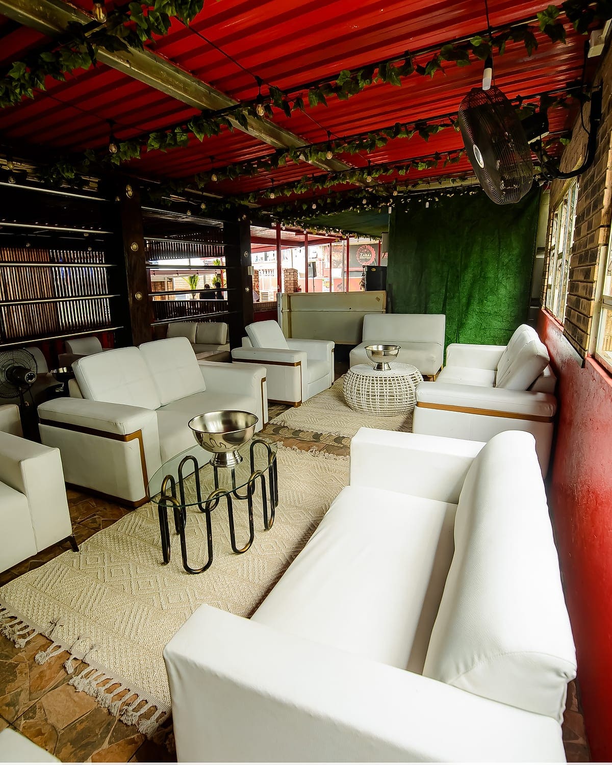 White couches and a rug in a private lounge area at Zaba's