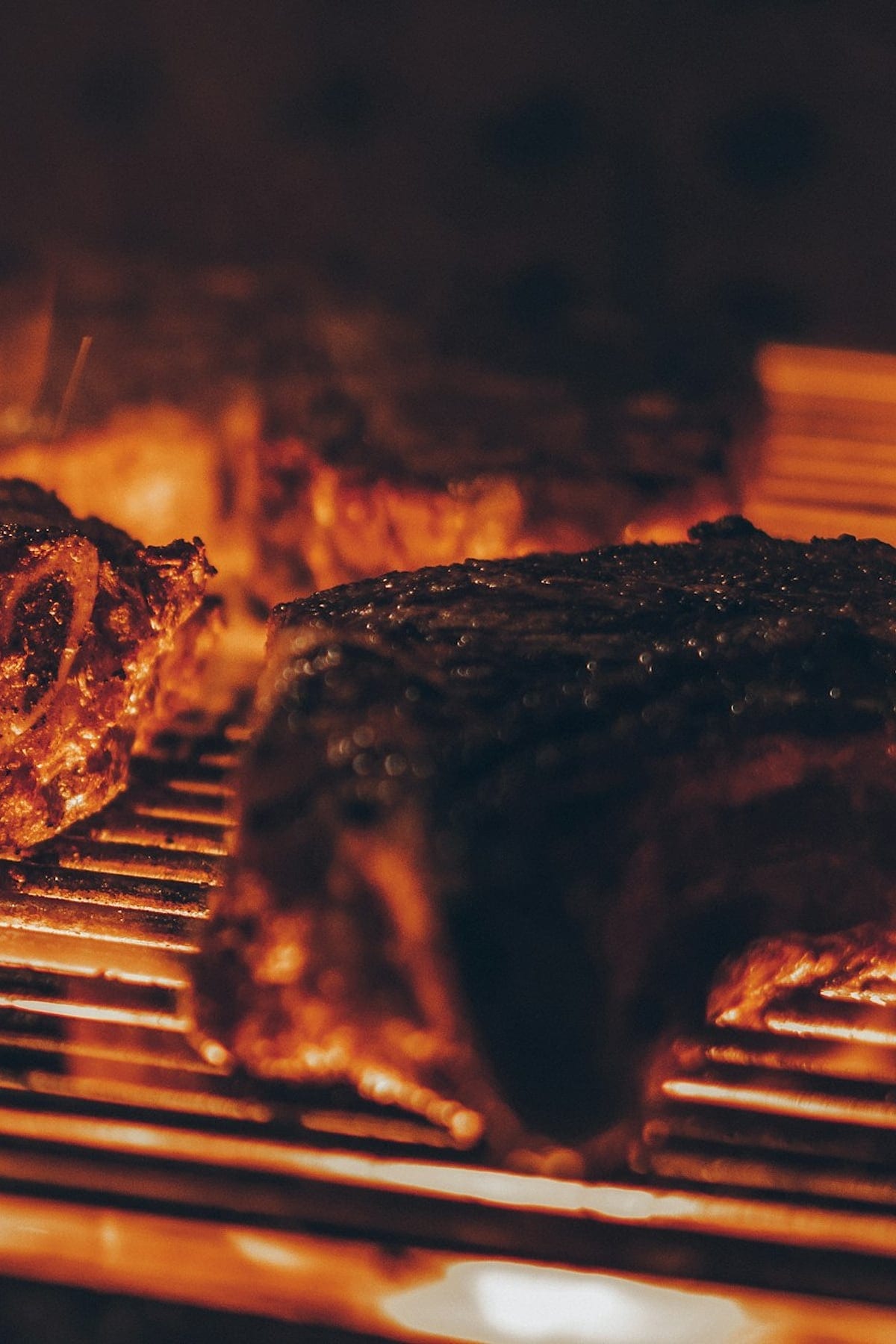 Flame-grilled boerewors, roast meat and pap on a wooden board at Zaba's Shisanyama